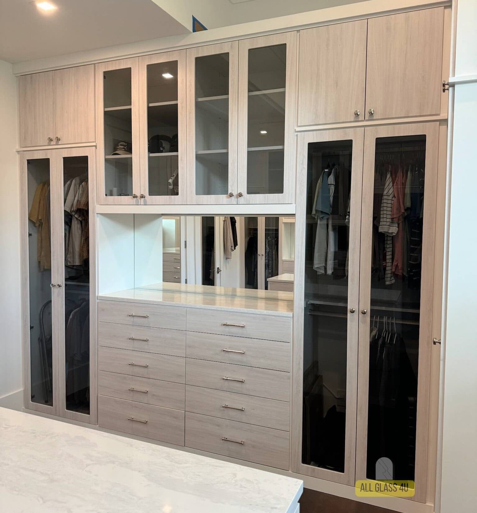 Glass cabinet door inserts in a custom closet